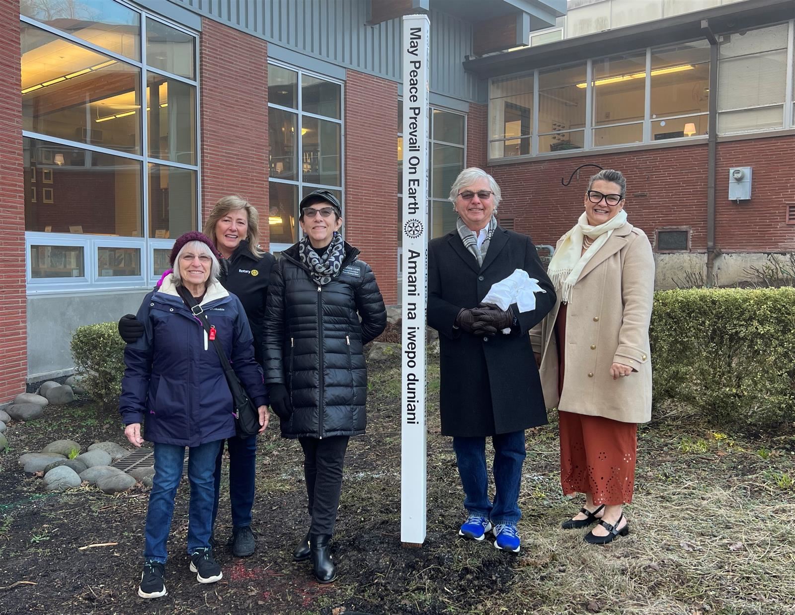 West Linn Rotary Club members unveil a new Peace Pole at Bolton Primary.